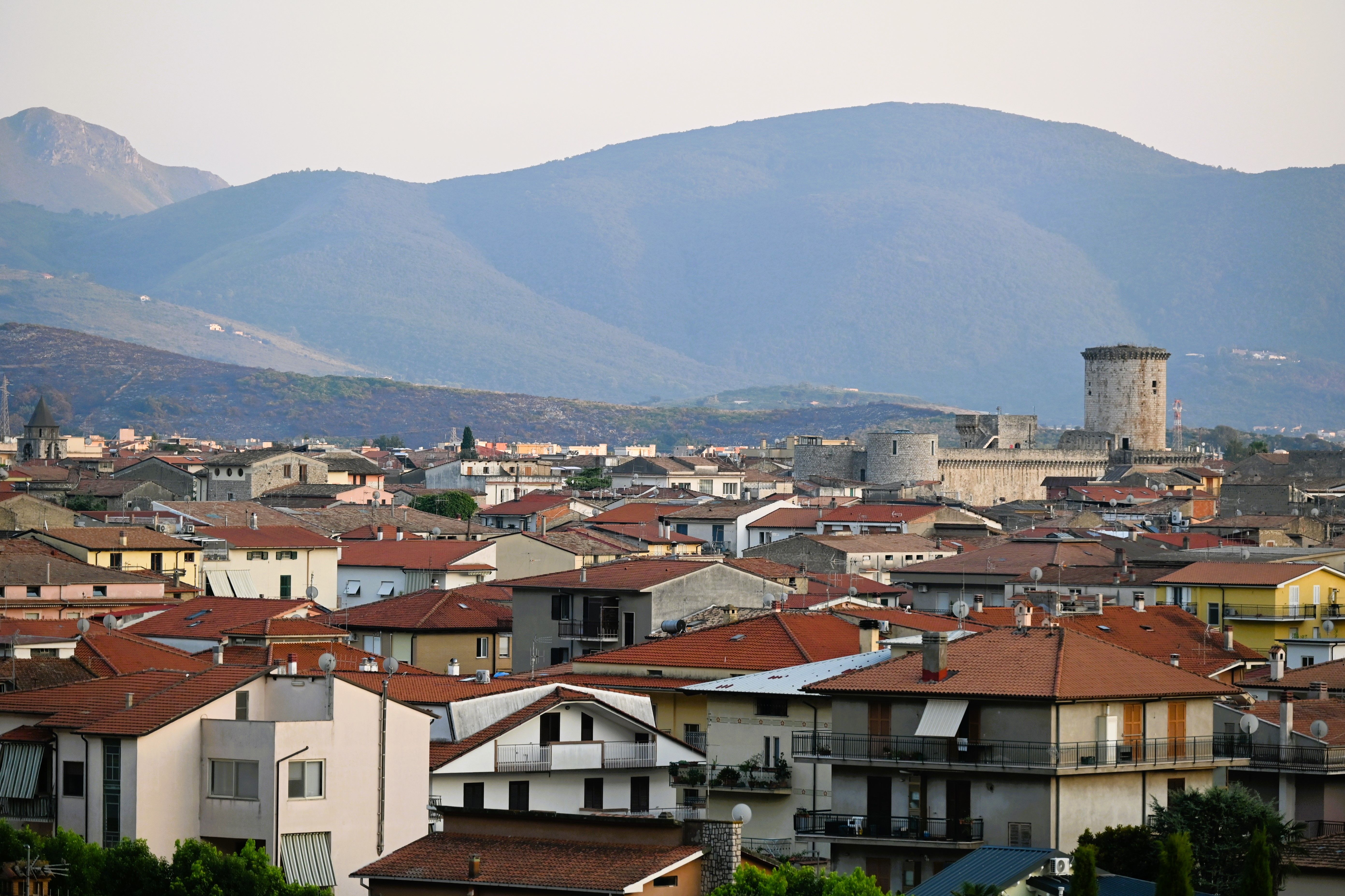 Panoramic view of Fondi, Italy showcasing historic architecture and scenic mountains in the background.