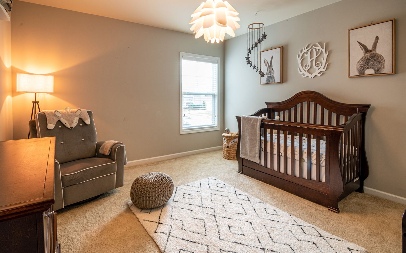 Warm and inviting nursery with an elegant wooden crib by a sunlit window
