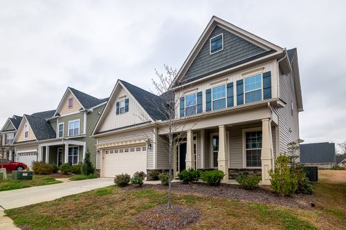 Row of suburban houses with front lawns — photo by Curtis Adams on Pexels