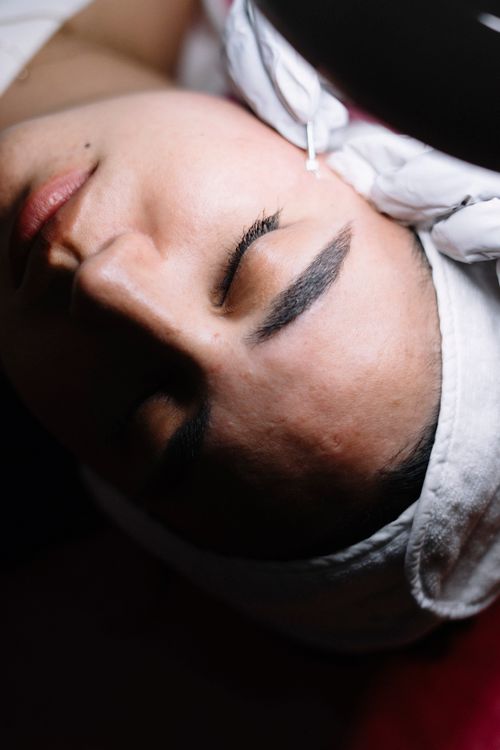 Free Close-up of a person receiving a soothing facial treatment at a spa. Stock Photo