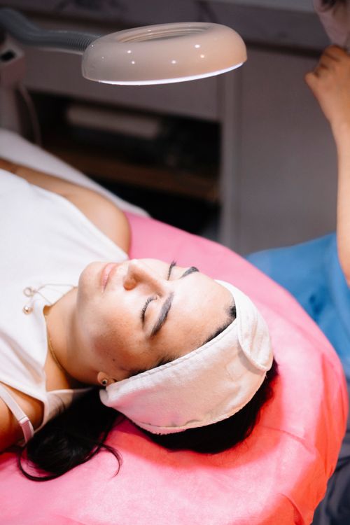 Free A woman relaxes during a professional skincare treatment session indoors. Stock Photo