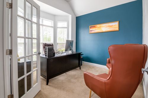 Home office with a desk, chair and glazed doors — photo by Curtis Adams on Pexels