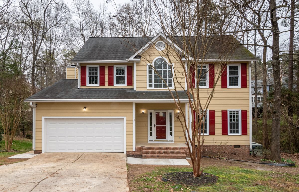 Exterior of a suburban home with siding, windows, foundation, and landscaping