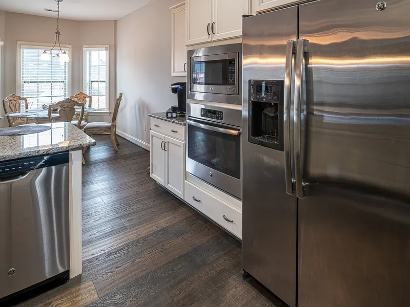 Spacious modern kitchen with steel appliances and a dining area Spacious modern kitchen with steel appliances and a dining area