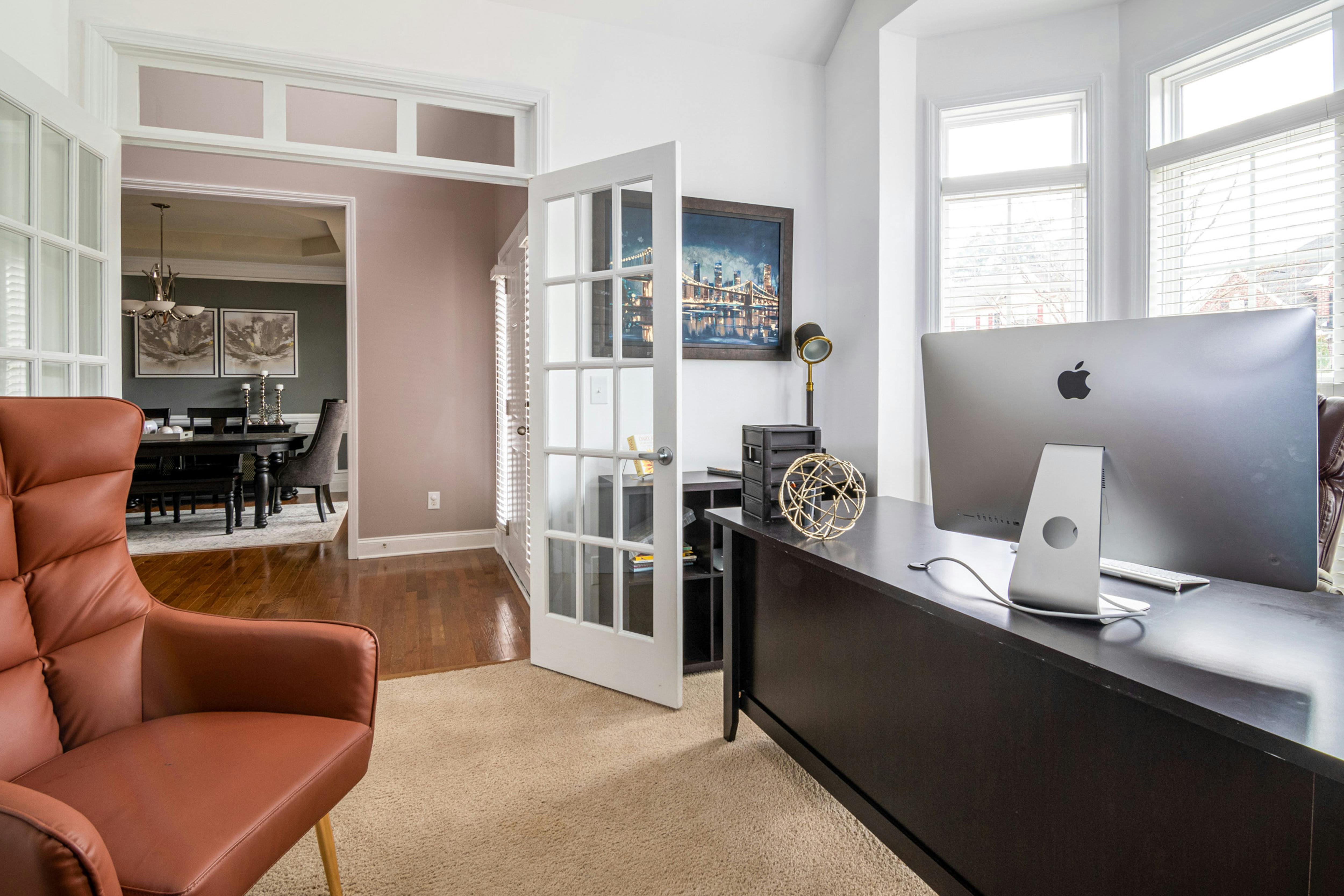 Bright home office interior featuring a modern design and large computer screen.