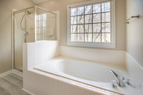 White Bathtub Near White Framed Window