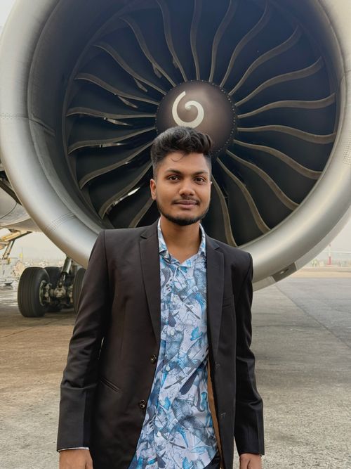Free Young man in suit standing in front of airplane jet engine at Dhaka airport. Stock Photo