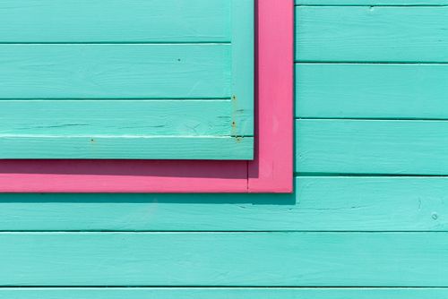 Free Close-up of colorful pink and turquoise wooden panels creating an abstract geometric design. Stock Photo