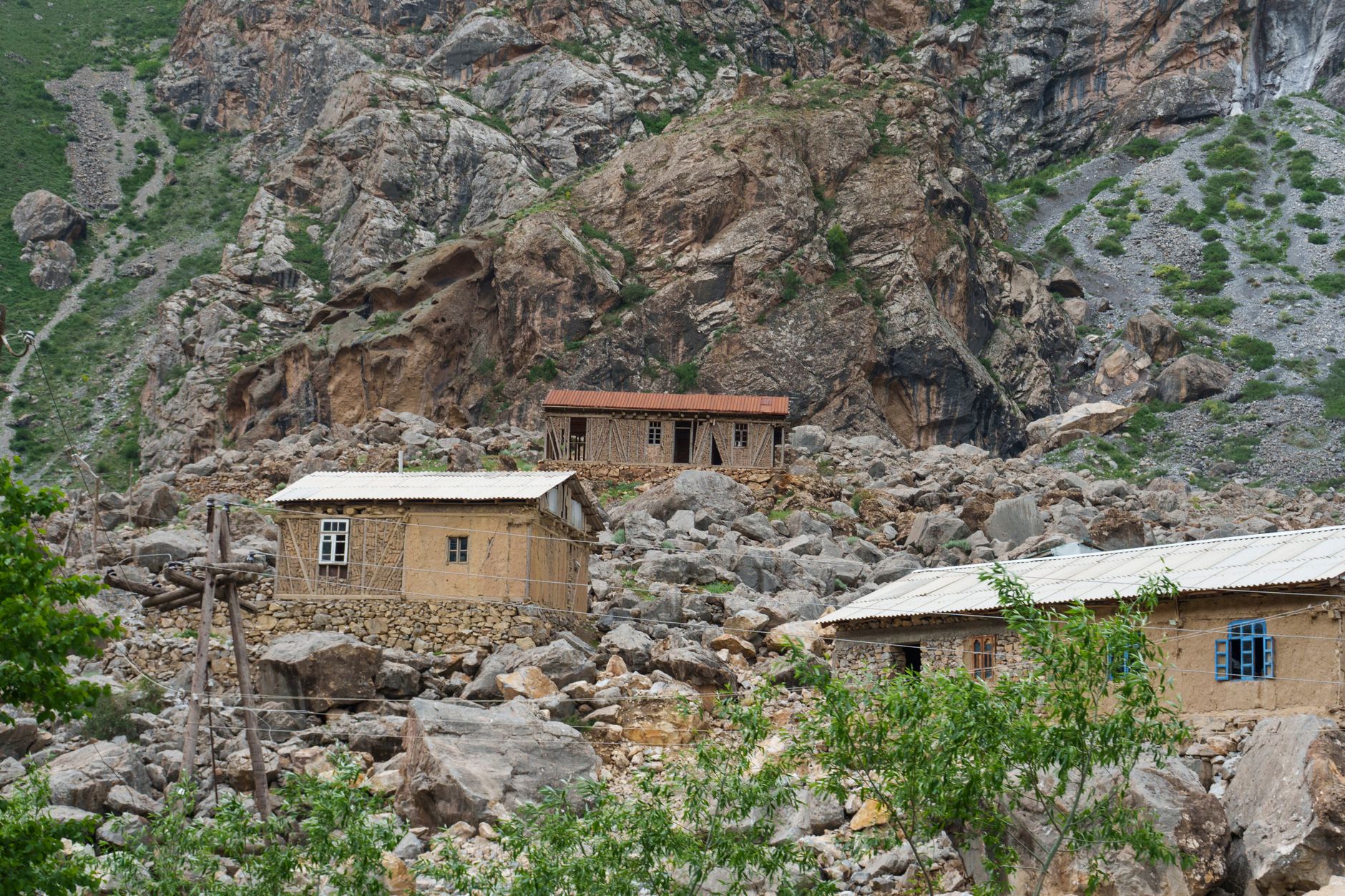 Rustic houses nestled in the rocky landscape of Tajikistan's Fann Mountains.