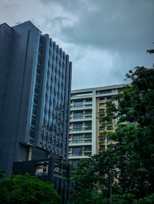 Free Skyline view of modern high-rise buildings against cloudy skies in Mumbai, India. Stock Photo