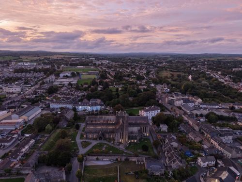 Free Breathtaking aerial shot of a historic cathedral set against a stunning sunset sky. Stock Photo