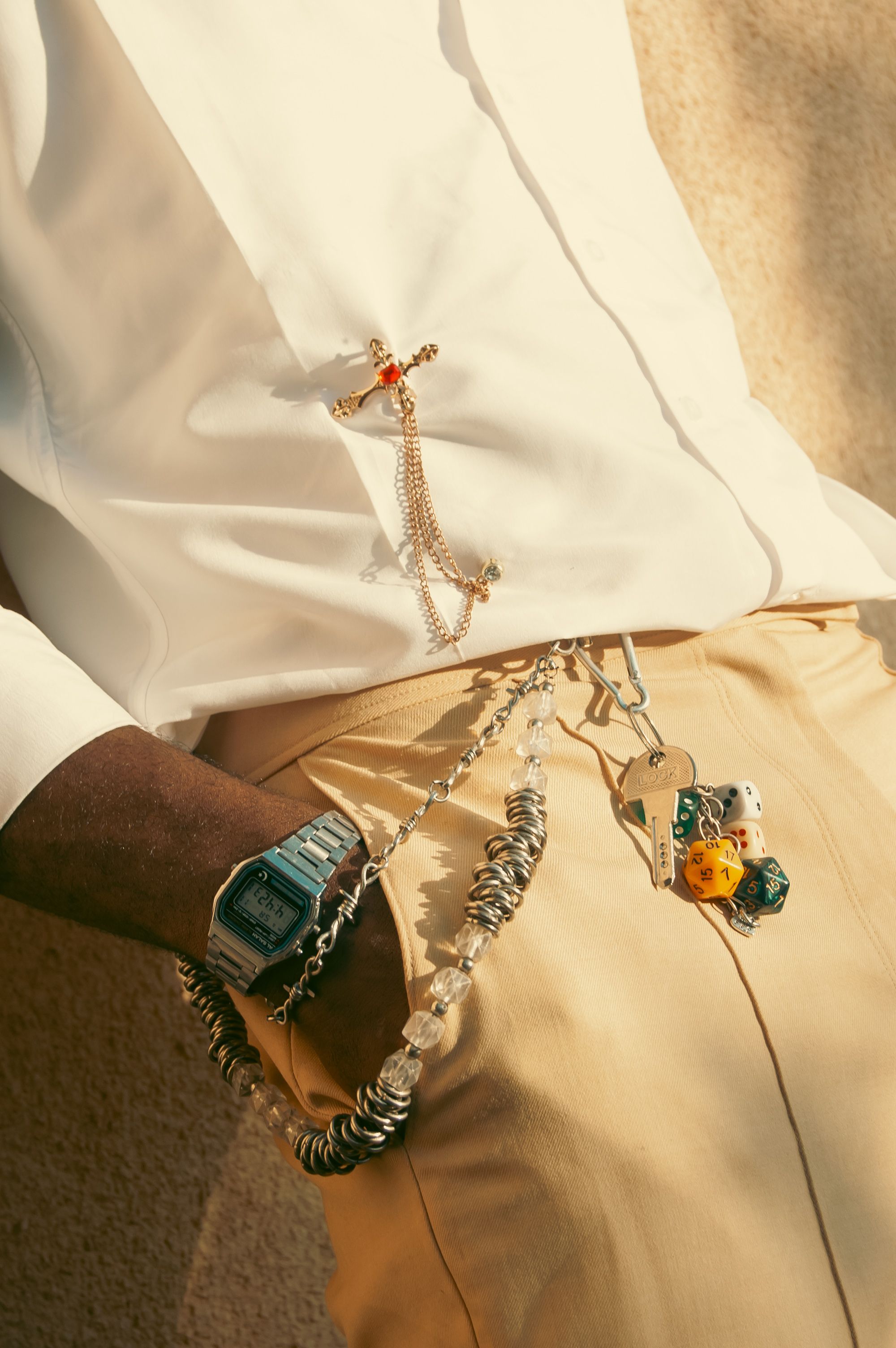Close-up of a person wearing jewelry and a casual outfit, showcasing fashion accessories.