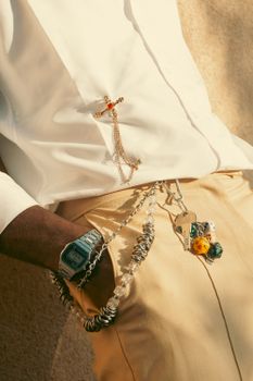 Close-up of a person wearing jewelry and a casual outfit, showcasing fashion accessories.