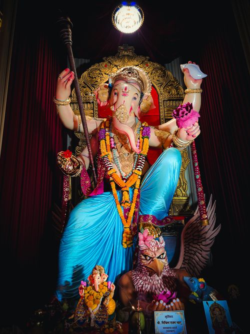 Free Spectacular Ganesha statue adorned with colorful garlands and traditional ornaments, symbolizing Hindu culture. Stock Photo