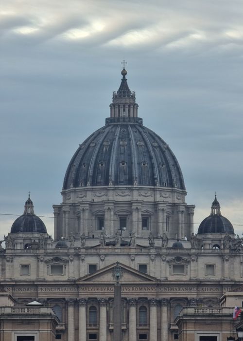 Free Close-up of St. Peter's Basilica dome in Vatican City with a cloudy sky backdrop, showcasing iconic architecture. Stock Photo