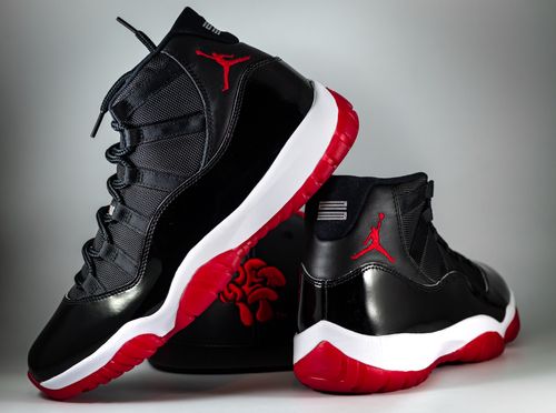 Free Stylish black and red high-top athletic sneakers displayed against a plain background. Stock Photo