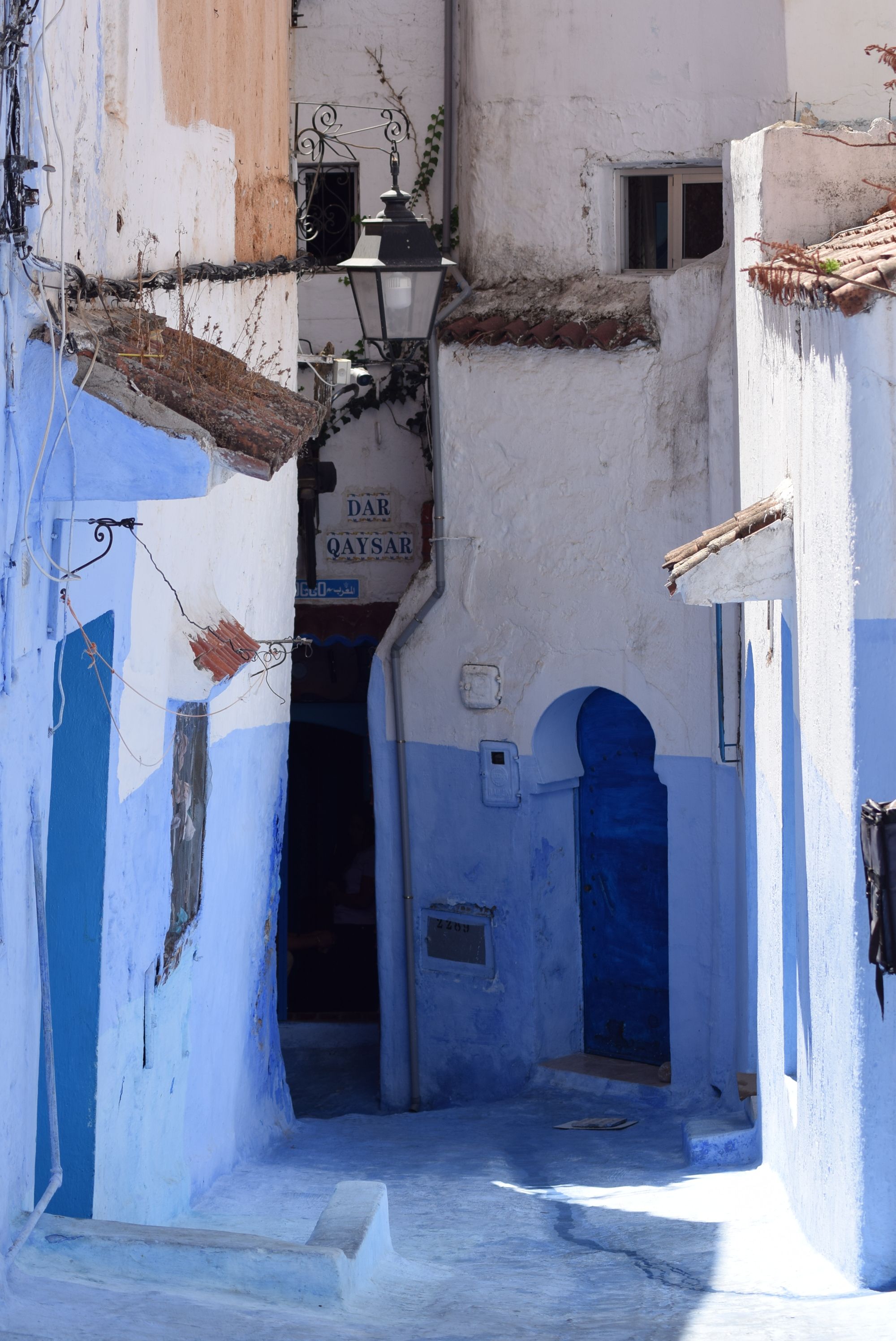 Picturesque blue alleyway in Chefchaouen, Morocco's famous blue city, showcasing traditional architecture.