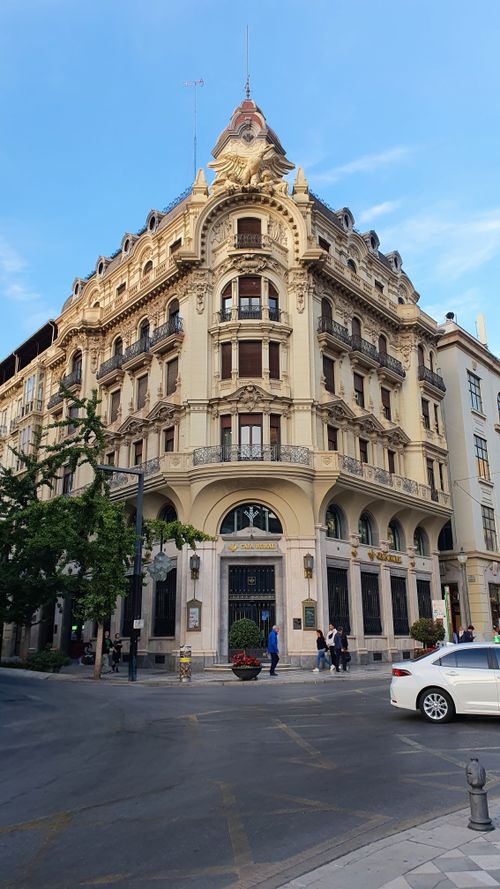 Free A classic European building showcasing ornate architectural design at a busy city intersection. Stock Photo