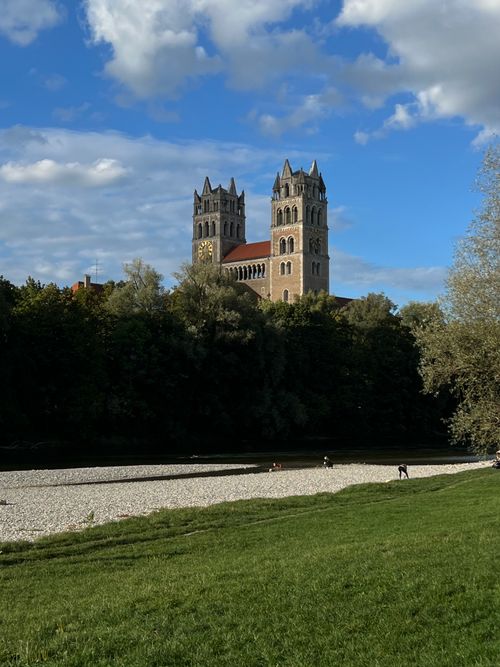 Free View of St. Maximilian Church in Munich against clear blue skies, with a peaceful park setting. Stock Photo