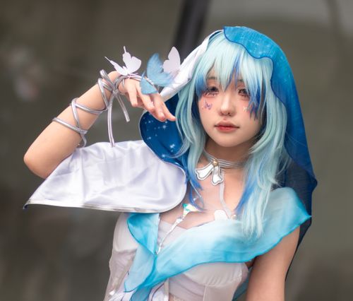 Free A captivating cosplay portrait featuring a person with blue hair, butterflies, and elaborate costume. Stock Photo