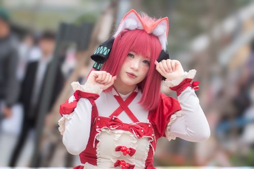 Free A vibrant cosplay enthusiast poses in a detailed anime costume during an outdoor event. Stock Photo