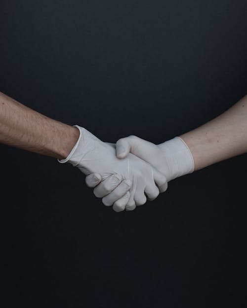 Free People Shaking Hands in Latex Gloves Stock Photo