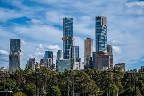 Free Stunning view of Melbourne's iconic Eureka Tower with a vibrant blue sky and clouds. Stock Photo