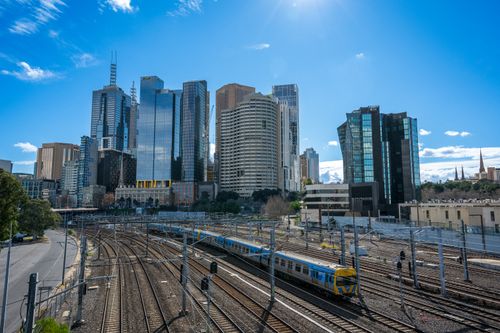 Free Modern Melbourne skyline with train tracks and blue sky. Stock Photo