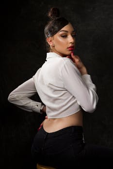 Sophisticated portrait of a young woman posing in stylish attire, emphasizing elegance and confidence.