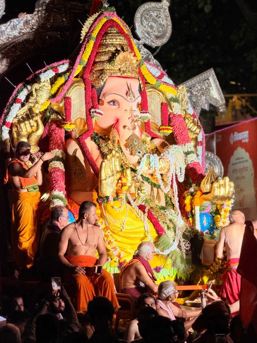 Free Colorful Ganesh idol procession during Mumbai's Ganesh Chaturthi festival at night with devotees. Stock Photo