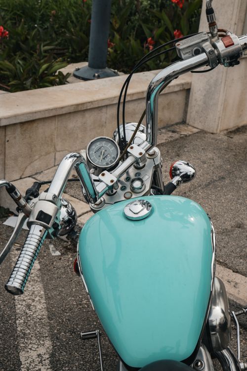 Free Turquoise motorcycle parked on a street in Split, Croatia with vibrant handlebar details. Stock Photo