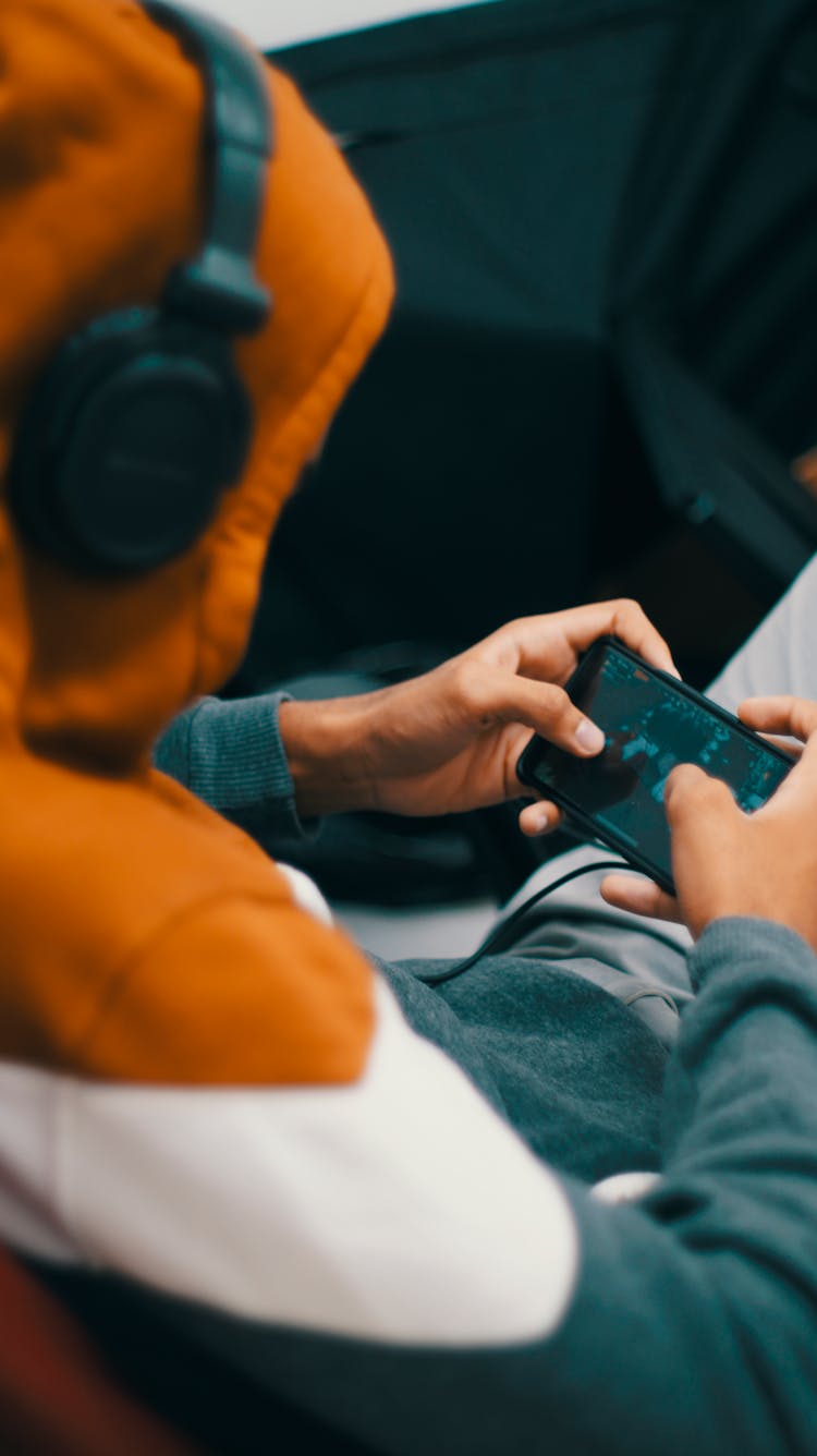 Person Playing Games On His Phone