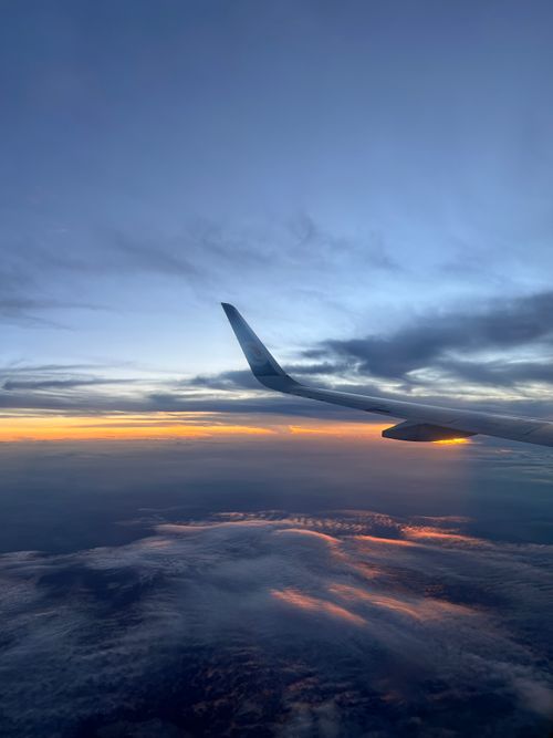 Free Stunning aerial view of an airplane wing with vibrant sunset clouds, capturing the serenity of twilight skies. Stock Photo