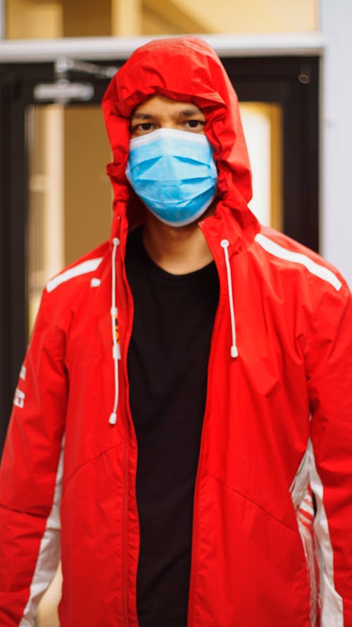 Man in Zip Up Hoodie Wearing Blue Mask