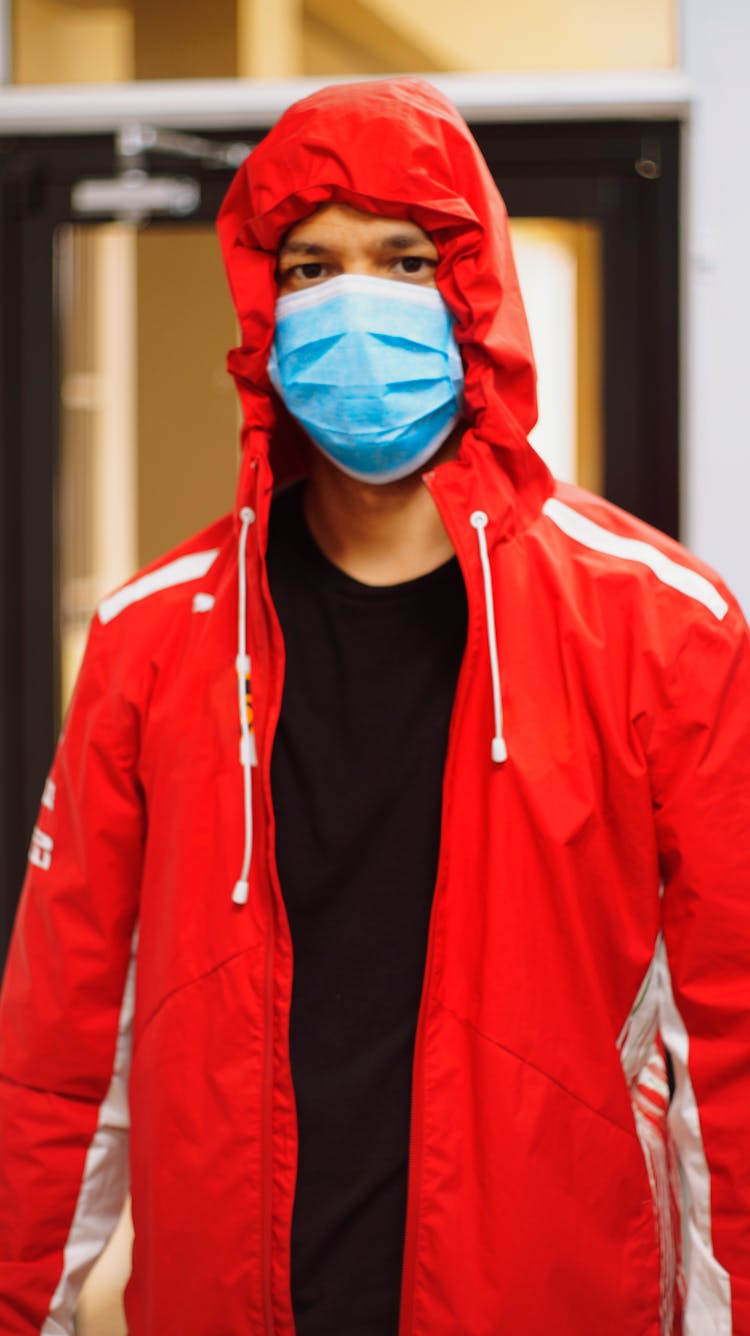 Man In Zip Up Hoodie Wearing Blue Mask