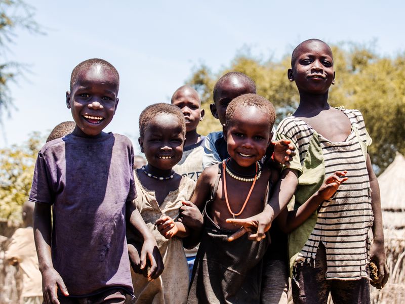 Children playing together outdoors under the bright sun
