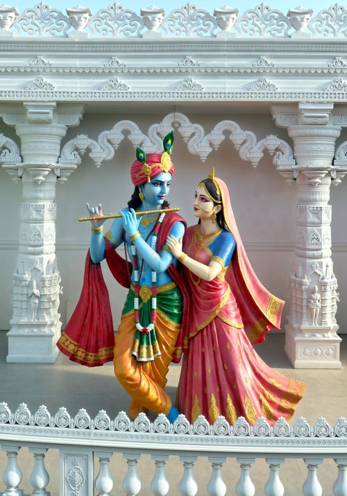 Free Colorful statues of Hindu deities Krishna and Radha in an ornate temple setting, exuding cultural richness. Stock Photo