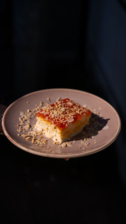 Free A close-up of a traditional Turkish trilece cake served on a plate with nuts. Stock Photo