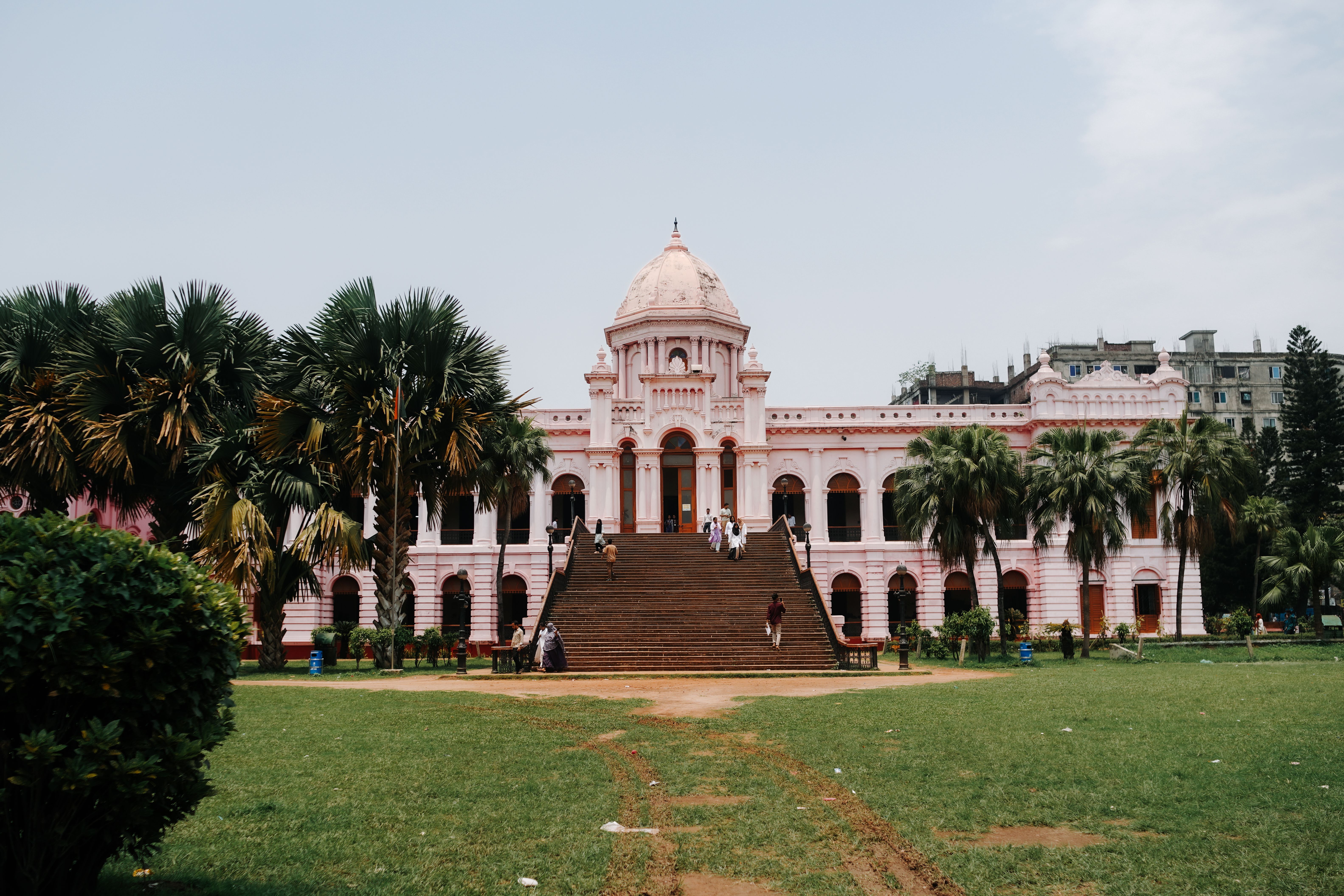 Ahsan Manzil, the iconic pink palace museum in Dhaka, Bangladesh, seen from the garden.