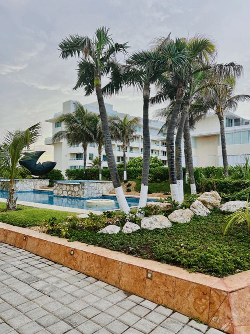 Free Vacation resort with palm trees and poolside views, offering relaxation and leisure. Stock Photo