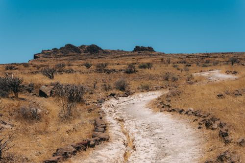 Free Explore the rugged volcanic landscape of Valle Gran Rey, Canary Islands, with its dry grass and rocky formations. Stock Photo