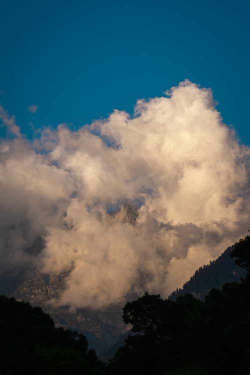 Free Majestic clouds envelop mountains during sunset in Dharamshala, Himachal Pradesh, India. Stock Photo