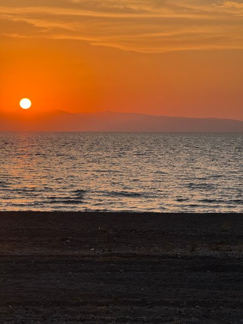 Free A breathtaking sunset view over the Marmara Sea with vibrant orange hues reflecting on the water. Stock Photo