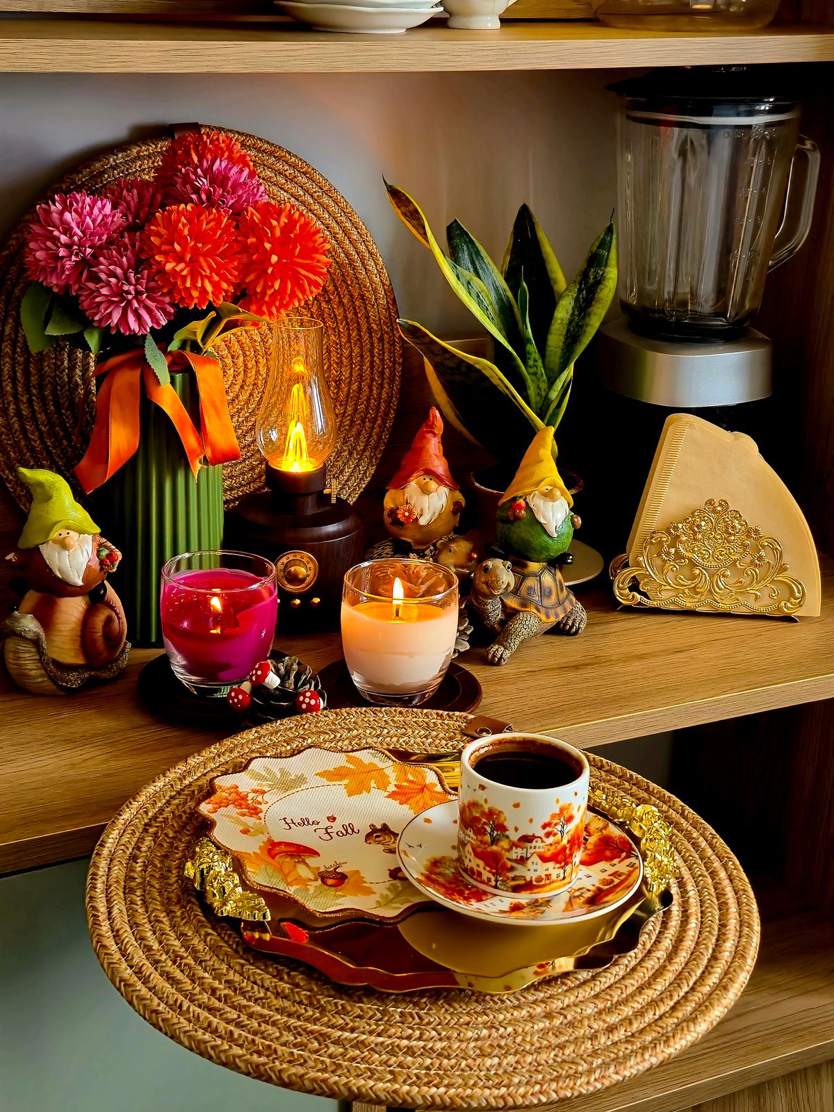 Warm autumn-themed shelf with candles, flowers, and decorative gnomes creating a cozy ambiance. Stock Photo.