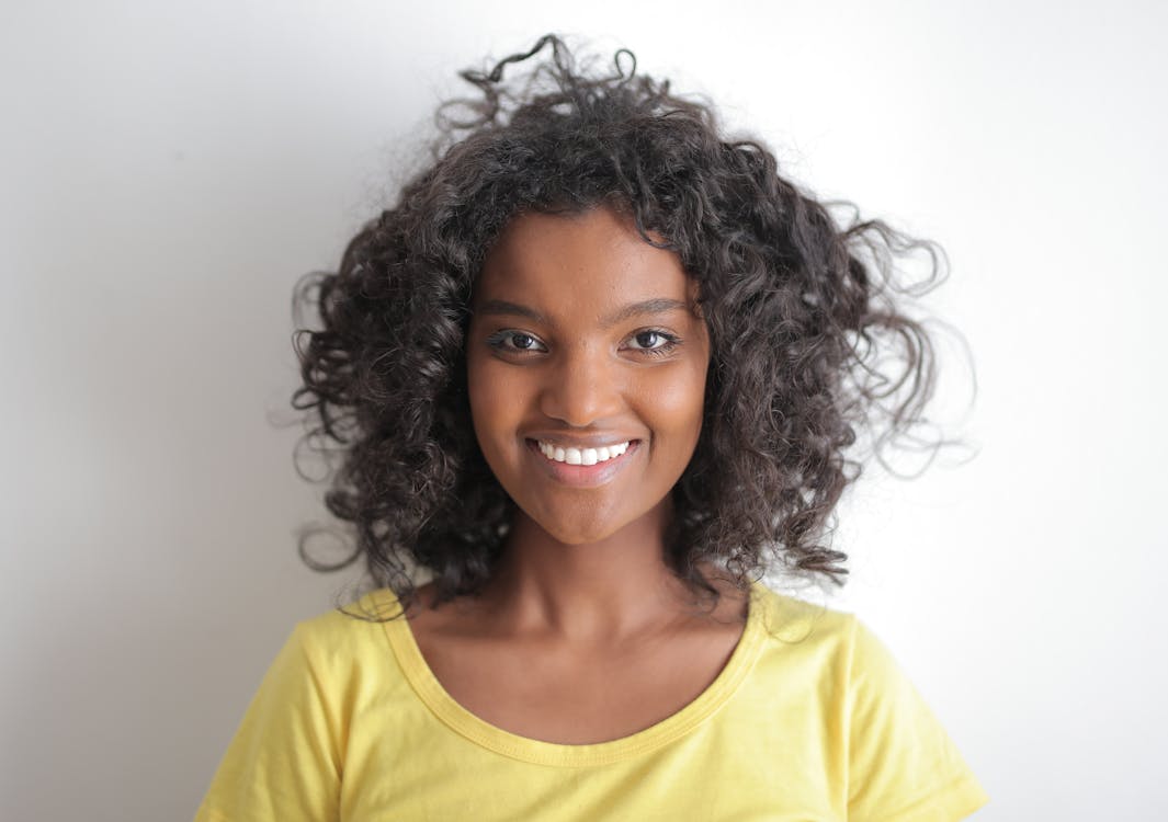 Happy African American female smiling at camera · Free Stock Photo