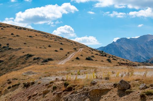 Free A serene mountainous landscape in Peristera, Greece, showcasing a rugged path under a clear blue sky. Stock Photo
