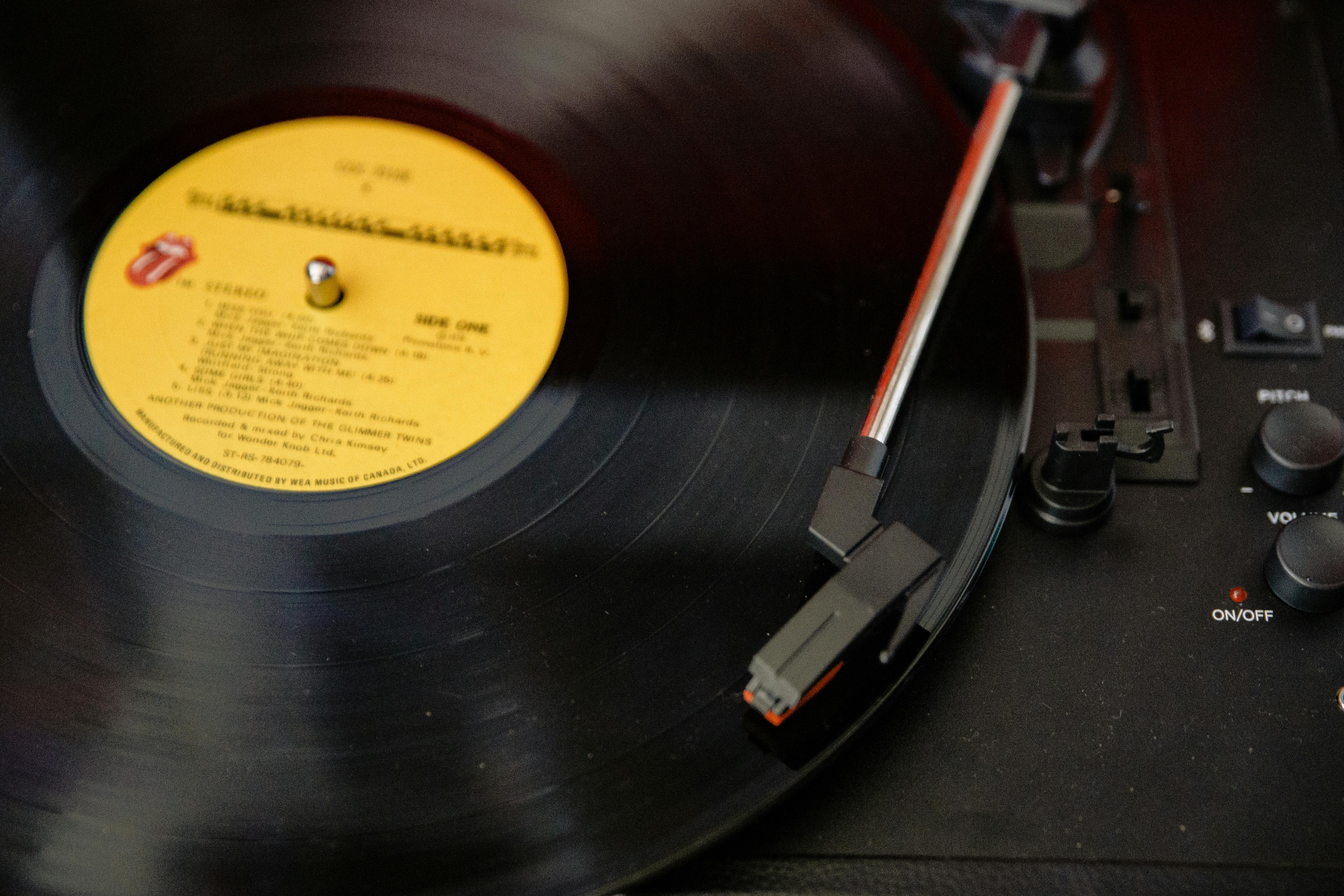 black vinyl record on vinyl record player