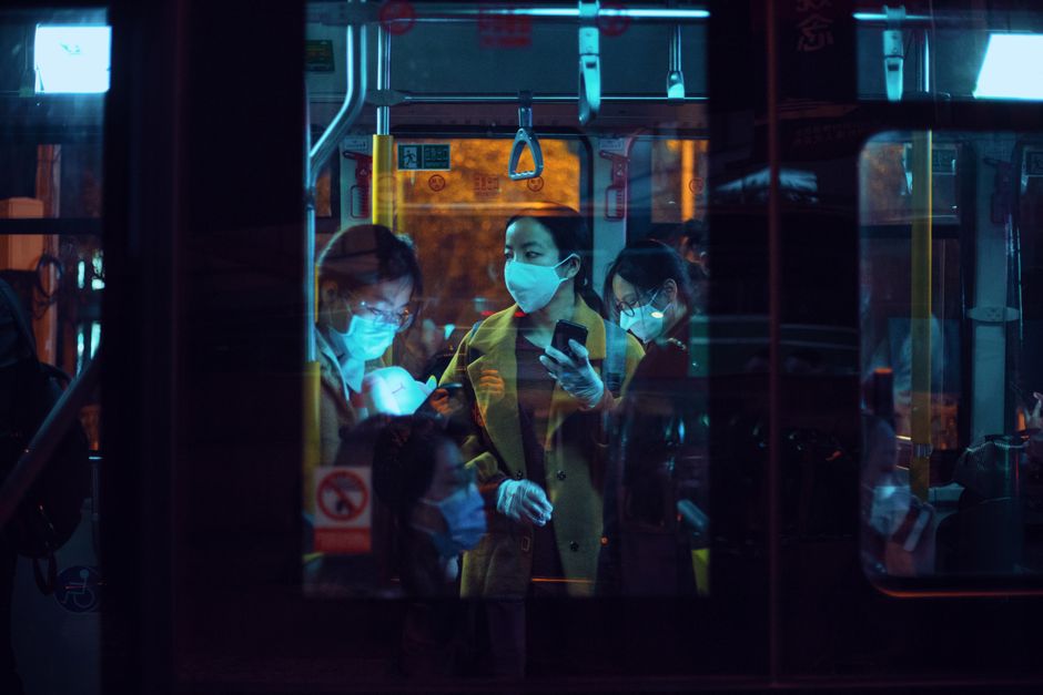 A scene of commuters wearing face masks on a Shanghai bus during the COVID-19 pandemic.