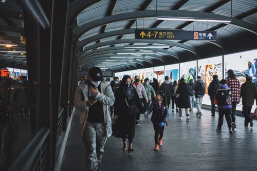 Free A busy scene of commuters wearing masks in a Shanghai subway station during the COVID-19 pandemic. Stock Photo