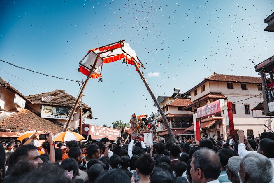Crowd gathers for festive Pilivesha performance during Janmashtami in Udupi, Karnataka, India.